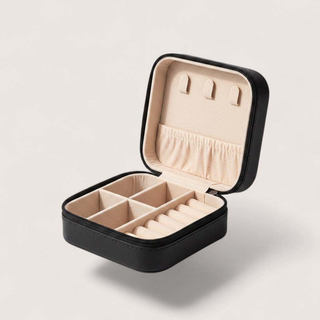 Magillas portable black travel jewelry case with champagne plush interior, ring rolls, and necklace hooks.