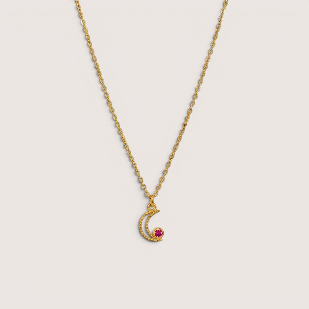Collar Magillas de acero inoxidable y rodio con colgante de luna y circonita magenta.