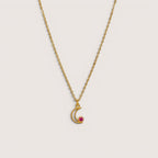 Collar Magillas de acero inoxidable y rodio con colgante de luna y circonita magenta.