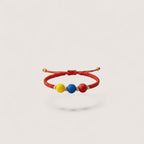 Magillas Colombian flag colors bracelet with yellow, blue, and red beads and gold accents.