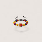 Magillas handmade Colombian flag soccer ball charm bracelet with yellow, blue, and red beads and gold spacers.
