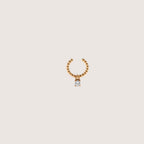Magillas earcuff pequeño de rodio con un pequeño colgante de circonita cúbica.