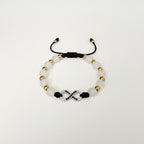 Magillas black beaded bracelet with gold infinity symbol and black rhinestones. Adjustable cord.