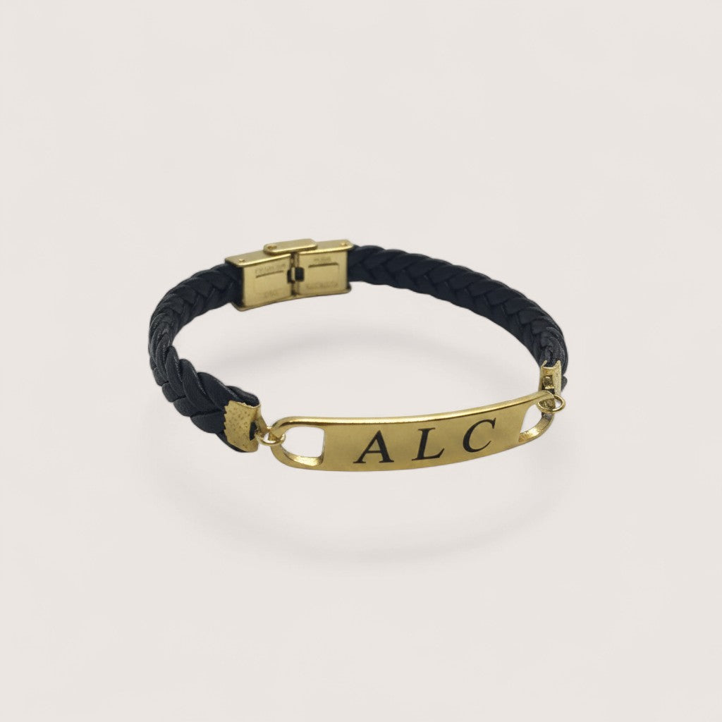 Pulsera esclava de cuero trenzado negro con placa personalizable de acero inoxidable dorado de Magillas.